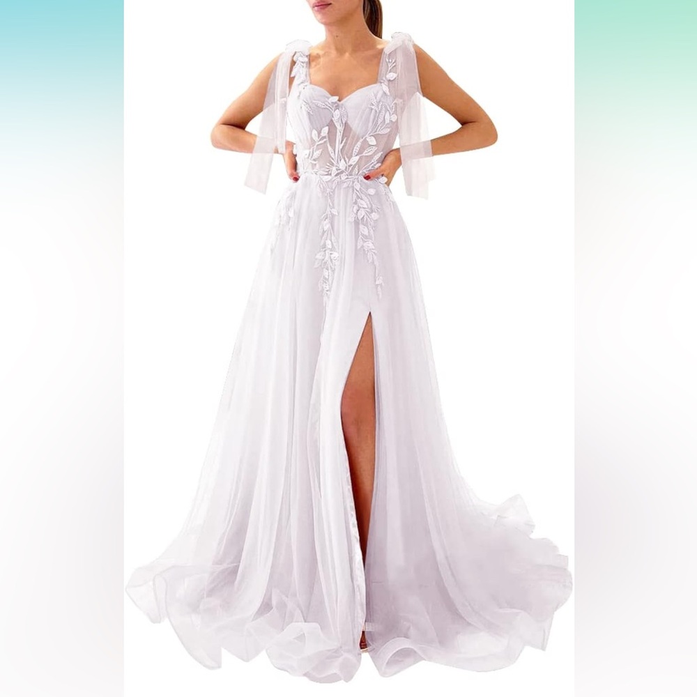 White bridal floor length tulle with high slit and sheer corset of appliqué